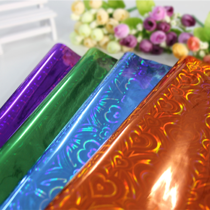 Bouquet wrapping paper material sunflower hollow flower packaging material flower shop laser film wholesale.