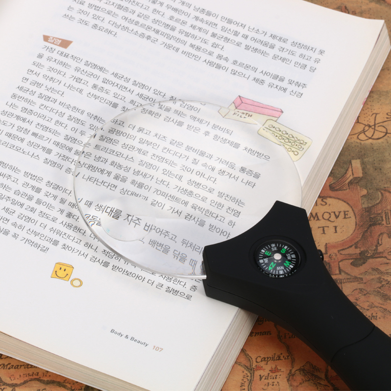Hand-held magnifier with light diffuser with compass elderly elderly and children reading magnifier