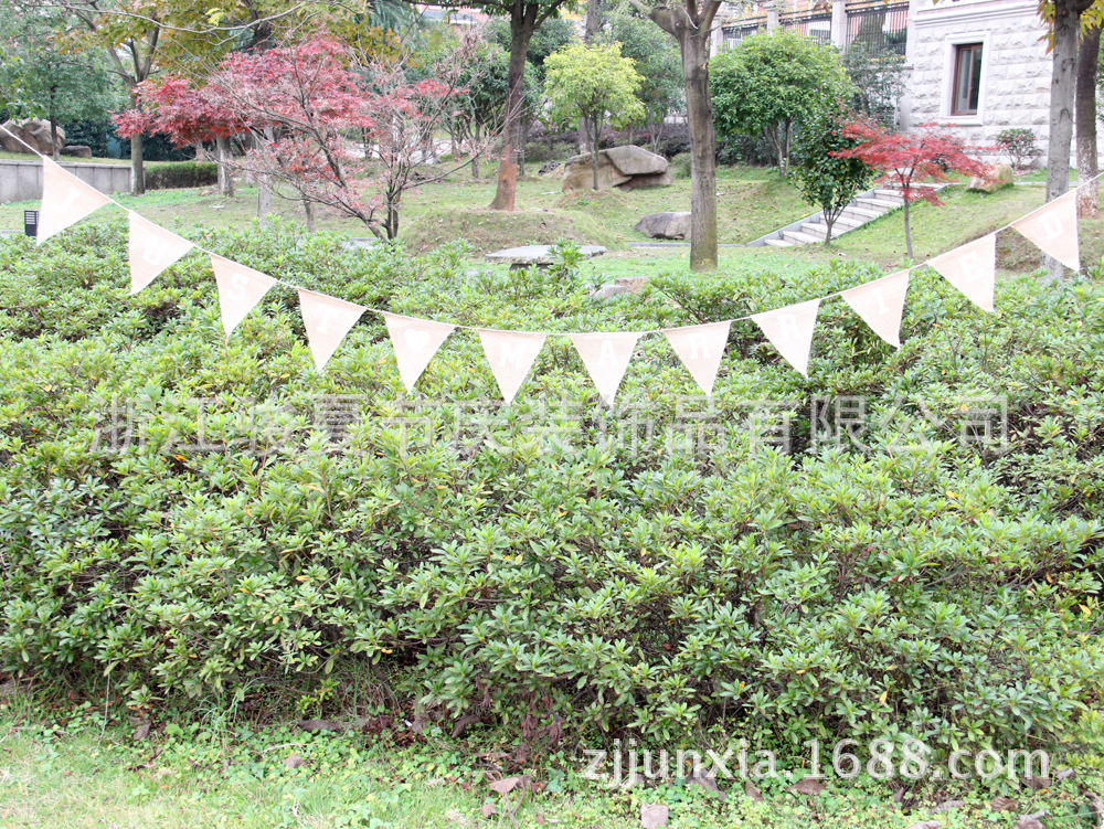Holiday party decoration: a wedding flag with a linen triangle on the hem Holiday party decoration: a wedding flag with a linen triangle on the hem